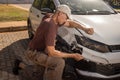 Man checking out the damage to the front end of his car Royalty Free Stock Photo