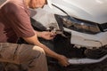 Man checking out the damage to the front end of his car Royalty Free Stock Photo