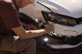 Man checking out the damage to the front end of his car Royalty Free Stock Photo