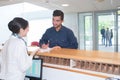 man checking in at reception desk Royalty Free Stock Photo