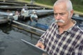 Man checking tablet at fishfarm Royalty Free Stock Photo