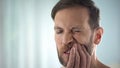 Man checking teeth in front of mirror, dental disease, gum infection, pulpitis Royalty Free Stock Photo