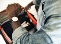 Man checking time from watch in hotel room Royalty Free Stock Photo