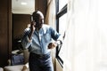 Man checking time from watch in hotel room Royalty Free Stock Photo