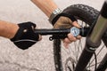 Man checking tire pressure of e bike, inflating air with hand pump Royalty Free Stock Photo