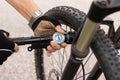 Man checking tire pressure of e bike, inflating air with hand pump Royalty Free Stock Photo