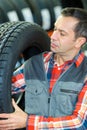 Man checking tyre in garage Royalty Free Stock Photo