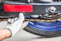 Man checks and Adjustments motorcycle chain on motorbike