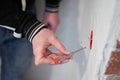 A man checks the current in a junction box with electrical wires using an indicator screwdriver. The concept of repair Royalty Free Stock Photo