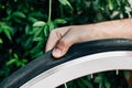 Man checks his bike wheel pressure