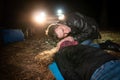 The man checks to see if the woman lying on the ground is breathing. Royalty Free Stock Photo