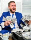 Man cheerful happy businessman with pile dollar banknotes. Profit and richness concept. Businessman formal suit hold Royalty Free Stock Photo
