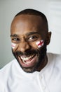 Man cheering football game with painted flag