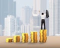 Man cheering on top of golden coins stacks