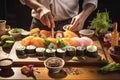 Man chef assembles vegetarian sushi set in restaurant kitchen Royalty Free Stock Photo