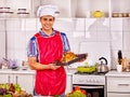 Man in chef hat cooking chicken