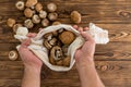 Man holding fresh raw mushrooms in a cloth Royalty Free Stock Photo