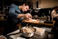 man chef holds handful of oyster mushrooms over bowl on kitchen