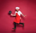 Man chef is scared for something. burgundy color background Royalty Free Stock Photo