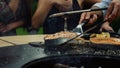 Man chef turning fish slice at bbq grill outside. Guy cooking with kitchen tools Royalty Free Stock Photo