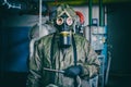 Man in chemical protection suit with radiation dosimeter