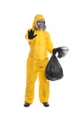 Man in chemical protective suit holding trash bag on white background. Virus research Royalty Free Stock Photo