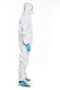 Side view of Young man in chemical protective suit making stop gesture on white background. Virus research Royalty Free Stock Photo