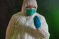 Man in chemical suit inspecting toxic materials