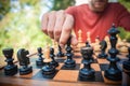 Man in chess game moves a piece, hand close up Royalty Free Stock Photo