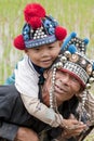 Man with child in Asia, Akha