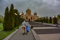 A man with a child on the background of the Church of St. Gregory the Illuminator in the center of Yerevan, May 2, 2019 Royalty Free Stock Photo