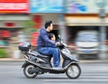 Man with child on an electric scooter, Shanghai, China