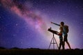 Man and child looking at stars through telescope Royalty Free Stock Photo