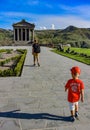 A man with a child near the temple of Garni pagan, a Greek temple in the Republic of Armenia. May 3, 2019. Royalty Free Stock Photo