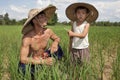 Man and child in the rice paddy, Thailand