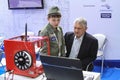A man and a child are studying a program for working on a 3D printer
