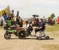 A man and child on a very small steam engine. Royalty Free Stock Photo