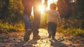 Man and Child Walking Down Dirt Road