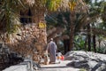 Man and child walking together in Misfat Al Abriyyin.