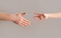 Man and children hands reach toward each other. Child and father hands  on gray. Small child& x27;s hand reaches Royalty Free Stock Photo