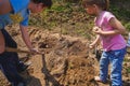 Man, children, kids dig soil, land with shovel, make garden beds for spring planting of potatoes. Good harvest. Family farming, Royalty Free Stock Photo