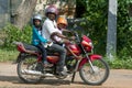 A man with children onboard riding a motorcycle at Puliyankulam in northern Sri Lanka.