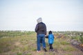 A man and children are standing on a rock and watching what is happening below. panoramic view from above. Russia, Rostov region, Royalty Free Stock Photo