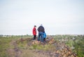 A man and children are standing on a rock and watching what is happening below. panoramic view from above. Russia, Rostov region, Royalty Free Stock Photo