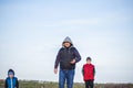 A man and children are standing on a rock and watching what is happening below. panoramic view from above. Russia, Rostov region, Royalty Free Stock Photo