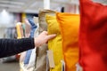 Man choices pillow in shop. Variety of colour pillows on shopping stand in supermarket Royalty Free Stock Photo