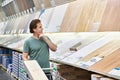 Man chooses board laminate in store Royalty Free Stock Photo