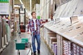 Man chooses floorboard for home renovation Royalty Free Stock Photo