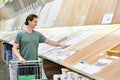 Man chooses floorboard laminate in store Royalty Free Stock Photo