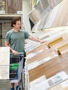 Man chooses floorboard laminate in shop Royalty Free Stock Photo